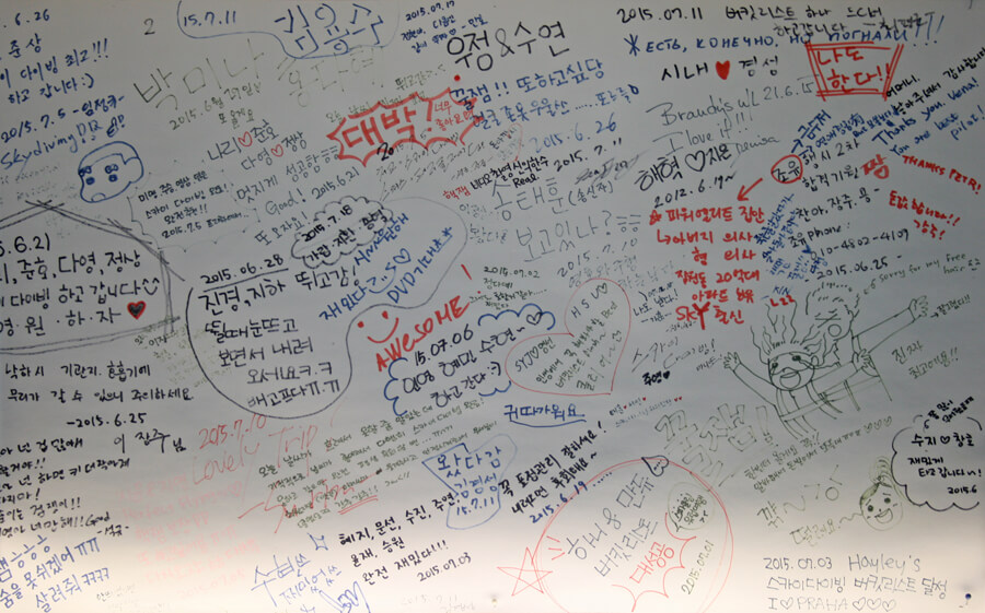 The densely covered message wall in the hangar at Mladá Boleslav airfield